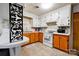 Classic kitchen featuring light countertops, two-tone cabinets, a tiled backsplash, and white appliances at 2005 Robyn Ave, Shelby, NC 28152