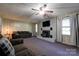 Inviting living room features a ceiling fan, brick fireplace, comfortable seating, and natural light at 2005 Robyn Ave, Shelby, NC 28152