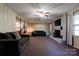 Inviting living room features a brick fireplace, ceiling fan, comfortable seating, and view to kitchen at 2005 Robyn Ave, Shelby, NC 28152