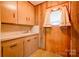 The mudroom sink area features wood-paneled walls and cabinets at 2005 Robyn Ave, Shelby, NC 28152