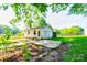 Detached outbuilding with concrete foundation surrounded by greenery and mature trees at 2005 Robyn Ave, Shelby, NC 28152