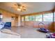 Spacious sunroom features wood paneling, ample natural light, and ceiling fan at 2005 Robyn Ave, Shelby, NC 28152