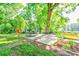 The backyard contains a trampoline and mature trees, creating a shady area for outdoor activities at 2005 Robyn Ave, Shelby, NC 28152