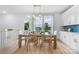 Cozy dining area featuring a chandelier, table setting, and view of outdoor scenery at 2146 Barrowcliffe Nw Dr, Concord, NC 28027