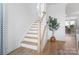 Elegant staircase with wood treads, white risers, and a traditional banister leading upstairs at 2146 Barrowcliffe Nw Dr, Concord, NC 28027