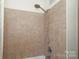 Simple bathroom with shower/tub combo and tile surround at 2701 Palm Ave, Charlotte, NC 28205