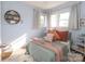 Cozy bedroom with a full-size bed and sunlit windows at 2701 Palm Ave, Charlotte, NC 28205