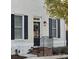 Front entrance with black shutters, brick steps and a wreath at 548 Summerfield Pl, Belmont, NC 28012