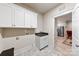 Clean laundry room with white cabinets and a utility sink at 548 Summerfield Pl, Belmont, NC 28012