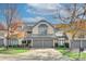 Two-story townhome with gray exterior, two-car garage, and landscaping at 5635 Ballinard Ln, Charlotte, NC 28277