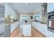 Spacious kitchen with island, stainless steel appliances, and hardwood floors at 5635 Ballinard Ln, Charlotte, NC 28277