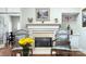 Fireplace with ornate mantel, two armchairs, and a view into a formal dining area at 5635 Ballinard Ln, Charlotte, NC 28277