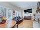 Living room with a large TV, comfortable seating, and hardwood floors at 5635 Ballinard Ln, Charlotte, NC 28277