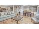 Living room with hardwood floors, light-colored sofa, and kitchen view at 5635 Ballinard Ln, Charlotte, NC 28277