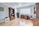 Home office with built-in shelving and hardwood floors at 5635 Ballinard Ln, Charlotte, NC 28277