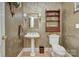 Elegant powder room with pedestal sink and decorative wallpaper at 5635 Ballinard Ln, Charlotte, NC 28277