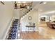 Elegant staircase with wrought-iron railing and runner at 5635 Ballinard Ln, Charlotte, NC 28277