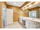 Bright bathroom featuring a double vanity, large mirror, and white cabinets at 7943 Oratorio Pl, Charlotte, NC 28270