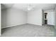 A spacious bedroom with neutral walls, carpet, a ceiling fan, and a view into the walk-in closet at 7943 Oratorio Pl, Charlotte, NC 28270