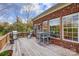 A rear wooden deck with a grill, chairs, and table at 7943 Oratorio Pl, Charlotte, NC 28270