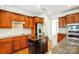 Kitchen featuring wood cabinets, stainless steel appliances, and an island at 7943 Oratorio Pl, Charlotte, NC 28270