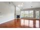 Living room with a fireplace, large windows, and hardwood floors at 7943 Oratorio Pl, Charlotte, NC 28270