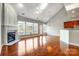 Open living room with a fireplace, hardwood floors, and a view of the kitchen at 7943 Oratorio Pl, Charlotte, NC 28270