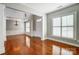 Open-concept living room featuring hardwood floors, natural light and detailed trim work at 7943 Oratorio Pl, Charlotte, NC 28270