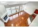 An open-concept living room with hardwood floors, a fireplace, and large windows at 7943 Oratorio Pl, Charlotte, NC 28270