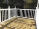 Exterior view of the back deck, made of wood with white railings at 8350 Nc Hwy 90 E Hwy, Stony Point, NC 28678