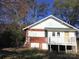 Exterior view of the backyard featuring a brick and clapboard exterior and a wooden deck at 8350 Nc Hwy 90 E Hwy, Stony Point, NC 28678