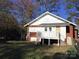 Exterior view of the backyard featuring a brick and clapboard exterior and a wooden deck at 8350 Nc Hwy 90 E Hwy, Stony Point, NC 28678