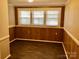 Bedroom featuring wood paneling, laminate floors, and an abundance of natural light at 8350 Nc Hwy 90 E Hwy, Stony Point, NC 28678