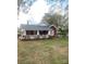 Inviting brick home with white trim, a charming front porch, and lush green lawn at 8350 Nc Hwy 90 E Hwy, Stony Point, NC 28678