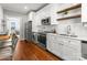 Modern kitchen with stainless steel appliances, white cabinetry, and wood countertops for a stylish cooking space at 843 Ideal Way # 11, Charlotte, NC 28203