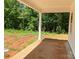 Covered back porch provides the perfect outdoor retreat overlooking a green backyard at 9130 Dulwich Dr # Ken0079, Charlotte, NC 28215