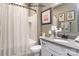 Bathroom with a shower/tub combo, gray vanity, and patterned shower curtain at 9130 Dulwich Dr # Ken0079, Charlotte, NC 28215