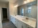 Elegant primary bathroom featuring a double vanity with white cabinets and quartz countertops at 9130 Dulwich Dr # Ken0079, Charlotte, NC 28215