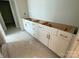 Bathroom vanity featuring white cabinets and sleek brass hardware at 9130 Dulwich Dr # Ken0079, Charlotte, NC 28215