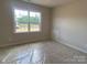 Well-lit bedroom featuring a window with natural light, offering a serene and comfortable space at 9130 Dulwich Dr # Ken0079, Charlotte, NC 28215