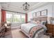 A bright bedroom with a decorative headboard, three windows and elegant furnishings at 9130 Dulwich Dr # Ken0079, Charlotte, NC 28215