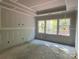 Unfinished bedroom featuring three large windows allowing ample natural light at 9130 Dulwich Dr # Ken0079, Charlotte, NC 28215