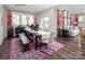 Open dining area with wooden table, bench, and colorful rug at 9130 Dulwich Dr # Ken0079, Charlotte, NC 28215