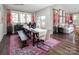 Elegant dining area with large windows, modern bench seating, and stylish decor at 9130 Dulwich Dr # Ken0079, Charlotte, NC 28215