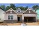 New construction with brick accents, covered front porch and two-car garage at 9130 Dulwich Dr # Ken0079, Charlotte, NC 28215