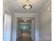 Bright hallway featuring stylish light fixtures and hardwood flooring leading to the living areas at 9130 Dulwich Dr # Ken0079, Charlotte, NC 28215