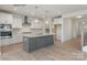 Modern kitchen with white cabinets, gray island, and stainless steel appliances at 9130 Dulwich Dr # Ken0079, Charlotte, NC 28215