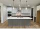 Modern kitchen with a large island, quartz countertops, and stainless steel appliances at 9130 Dulwich Dr # Ken0079, Charlotte, NC 28215