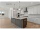 Open kitchen with white cabinets, large island, and stainless steel appliances at 9130 Dulwich Dr # Ken0079, Charlotte, NC 28215