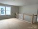 Second floor landing featuring natural light and modern wood and white railing at 9130 Dulwich Dr # Ken0079, Charlotte, NC 28215